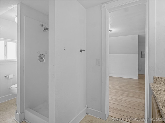 148 W 4th, Atoka, OK 74525 - bathroom with vanity, a stall shower, toilet, and baseboards