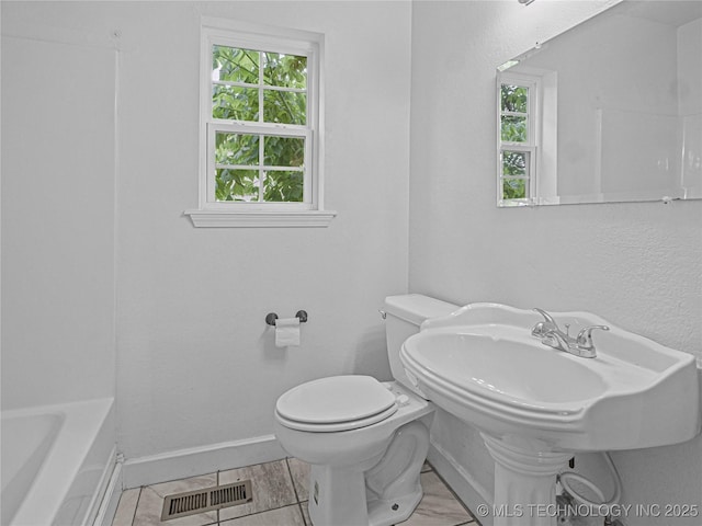 148 W 4th, Atoka, OK 74525 - full bath featuring toilet, baseboards, and a tub to relax in