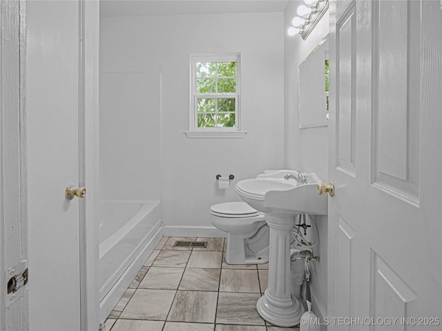 148 W 4th, Atoka, OK 74525 - full bathroom featuring toilet, baseboards, and marble finish flooring