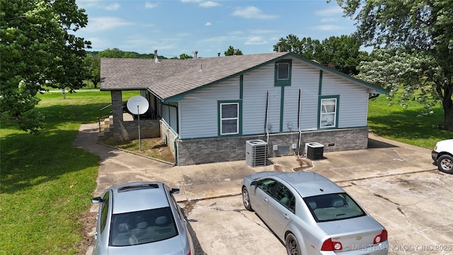 15291 S 4187th Rd, Claremore, OK 74017 - view of front of property featuring a front lawn, cooling unit, brick siding, and a shingled roof