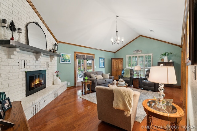 living room featuring lofted ceiling, wood finished floors, a fireplace, a chandelier, and crown molding
