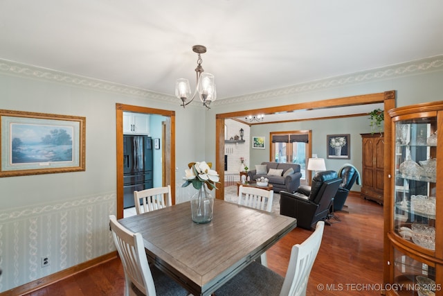 dining space featuring a chandelier and wood finished floors