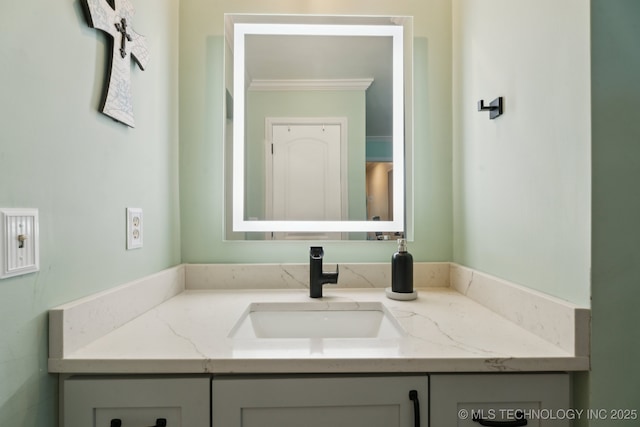 bathroom with vanity and ornamental molding