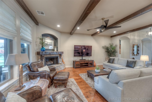 6623 E 134th Pl S, Bixby, OK 74008 - living room with beam ceiling, wood finished floors, baseboards, ceiling fan, and a fireplace