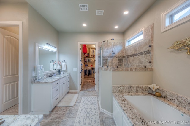 6623 E 134th Pl S, Bixby, OK 74008 - full bathroom featuring walk in shower, vanity, a bath, a walk in closet, and recessed lighting