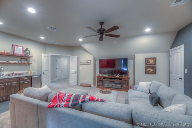 6623 E 134th Pl S, Bixby, OK 74008 - living room with vaulted ceiling, ceiling fan, recessed lighting, bar area, and light colored carpet