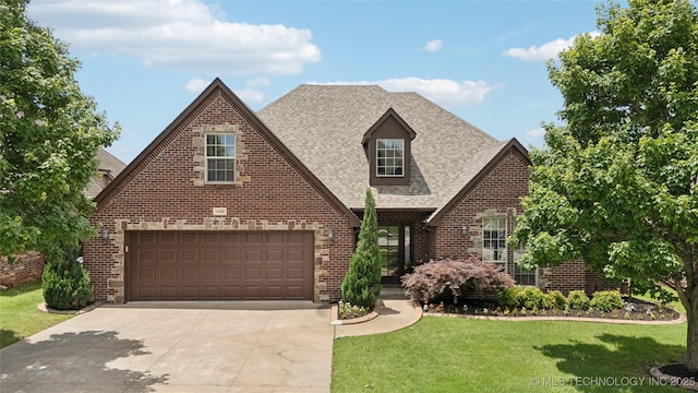 14538 S Urbana Ct, Bixby, OK 74008 - tudor home with brick siding, driveway, a front yard, and a shingled roof