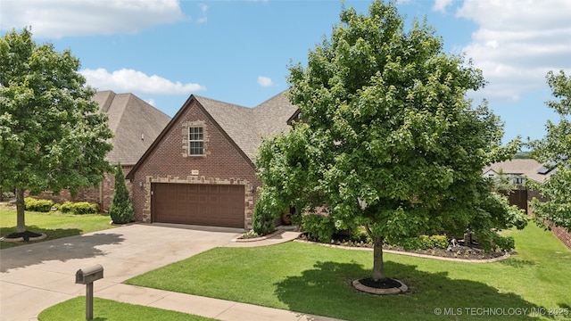 14538 S Urbana Ct, Bixby, OK 74008 - view of front of home featuring brick siding, driveway, a front yard, and roof with shingles