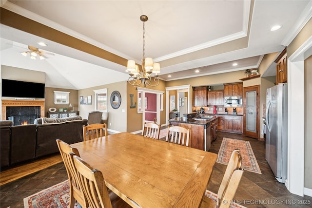 14538 S Urbana Ct, Bixby, OK 74008 - dining room featuring crown molding, a chandelier, a tray ceiling, a ceiling fan, and recessed lighting