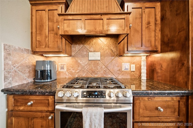14538 S Urbana Ct, Bixby, OK 74008 - kitchen with stainless steel gas stove, brown cabinets, decorative backsplash, and custom exhaust hood