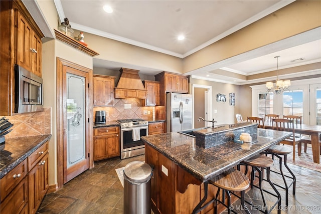 14538 S Urbana Ct, Bixby, OK 74008 - kitchen with appliances with stainless steel finishes, premium range hood, ornamental molding, a breakfast bar, and decorative backsplash