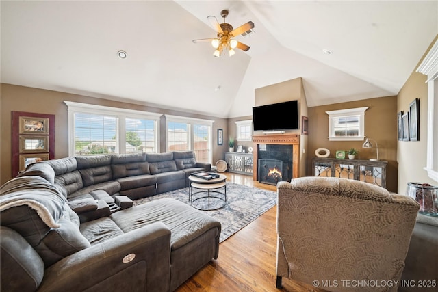 14538 S Urbana Ct, Bixby, OK 74008 - living area featuring ceiling fan, wood finished floors, a glass covered fireplace, and high vaulted ceiling