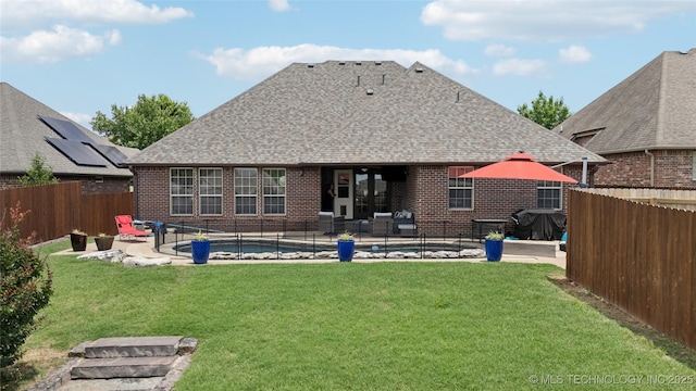 14538 S Urbana Ct, Bixby, OK 74008 - back of house featuring a patio area, a shingled roof, and brick siding
