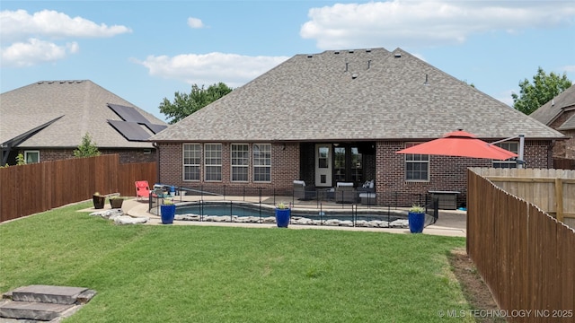 14538 S Urbana Ct, Bixby, OK 74008 - back of house featuring brick siding, roof with shingles, and a patio