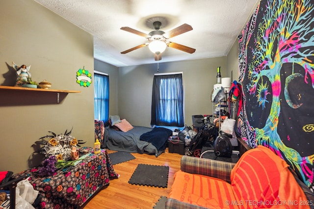 408 S Phoenix Ave, Tulsa, OK 74127 - bedroom with wood finished floors, a textured ceiling, and ceiling fan