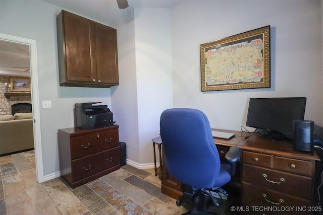 17061 S Creekwood Trl, Claremore, OK 74017 - office area with a ceiling fan, a stone fireplace, and baseboards