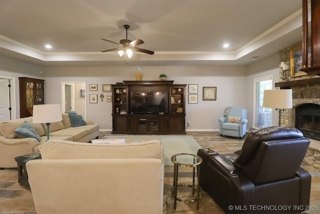 17061 S Creekwood Trl, Claremore, OK 74017 - living room featuring a tray ceiling, ceiling fan, a fireplace, baseboards, and recessed lighting