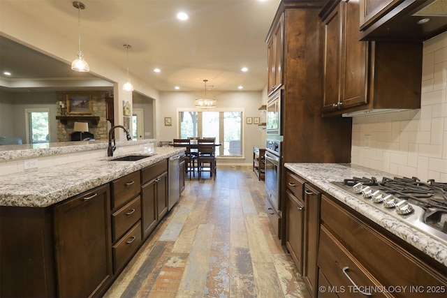 17061 S Creekwood Trl, Claremore, OK 74017 - kitchen featuring a sink, appliances with stainless steel finishes, hardwood / wood-style floors, dark brown cabinets, and recessed lighting