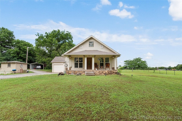 616 S Schlegel, Cushing, OK 74023 - view of front facade with a porch, dirt driveway, a carport, and a garage