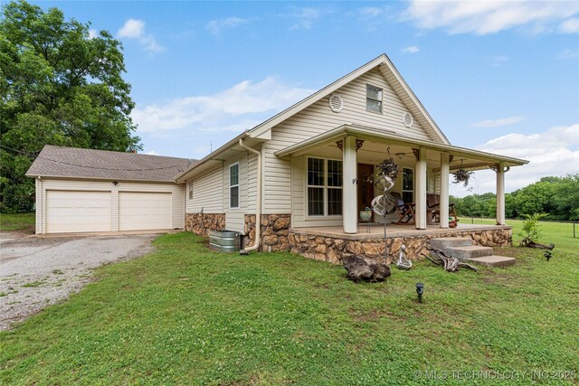 616 S Schlegel, Cushing, OK 74023 - view of front of home with a front yard, driveway, and stone siding