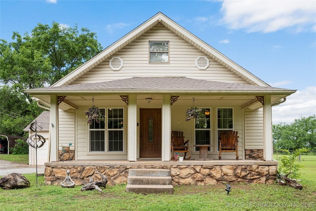 616 S Schlegel, Cushing, OK 74023 - view of front of property with a porch, a front lawn, a shingled roof, and a garage