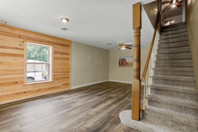 616 S Schlegel, Cushing, OK 74023 - stairs featuring ceiling fan, wooden walls, wood finished floors, and baseboards