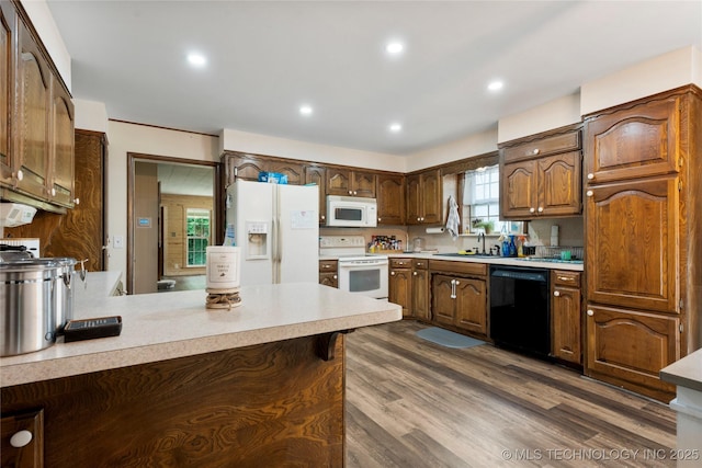 616 S Schlegel, Cushing, OK 74023 - kitchen with white appliances, a sink, light countertops, dark wood finished floors, and recessed lighting
