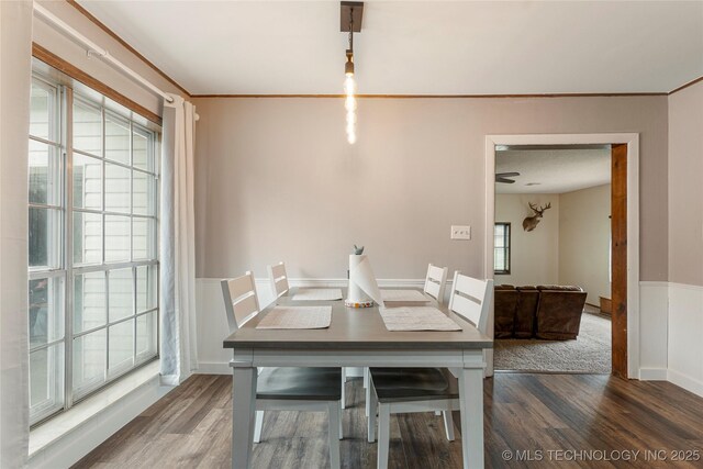 616 S Schlegel, Cushing, OK 74023 - dining space featuring wood finished floors, ornamental molding, a wainscoted wall, and baseboards