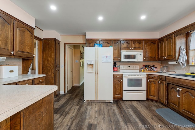 616 S Schlegel, Cushing, OK 74023 - kitchen with white appliances, light countertops, tasteful backsplash, dark wood-style flooring, and recessed lighting