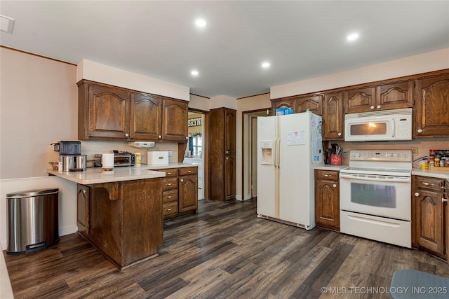 616 S Schlegel, Cushing, OK 74023 - kitchen featuring white appliances, dark wood-type flooring, light countertops, a peninsula, and recessed lighting