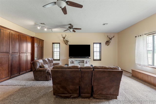 616 S Schlegel, Cushing, OK 74023 - living area with light carpet, ceiling fan, healthy amount of natural light, and a textured ceiling