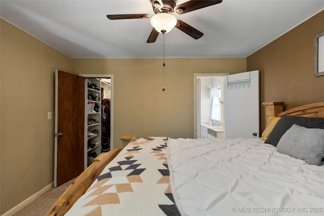 616 S Schlegel, Cushing, OK 74023 - bedroom with crown molding, a walk in closet, carpet flooring, a closet, and ensuite bathroom