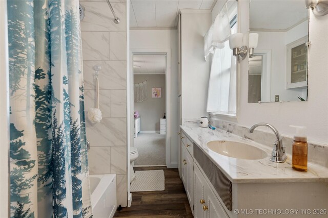 616 S Schlegel, Cushing, OK 74023 - bathroom featuring crown molding, toilet, vanity, wood finished floors, and shower / tub combo
