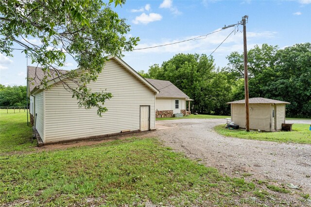 616 S Schlegel, Cushing, OK 74023 - view of side of property with a lawn and dirt driveway