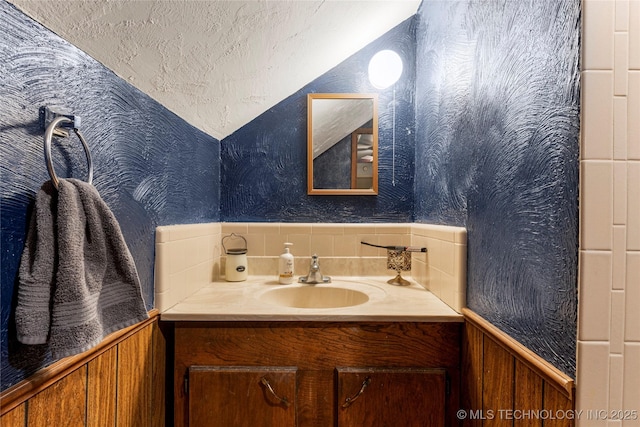 616 S Schlegel, Cushing, OK 74023 - bathroom featuring vanity, wallpapered walls, and wainscoting