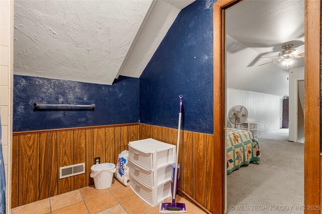 616 S Schlegel, Cushing, OK 74023 - bathroom featuring lofted ceiling, a textured ceiling, wooden walls, ceiling fan, and wainscoting