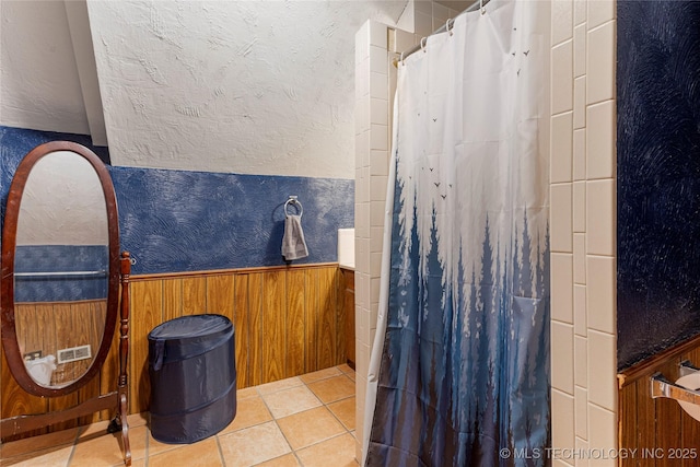 616 S Schlegel, Cushing, OK 74023 - bathroom featuring a wainscoted wall, curtained shower, tile patterned flooring, and wooden walls