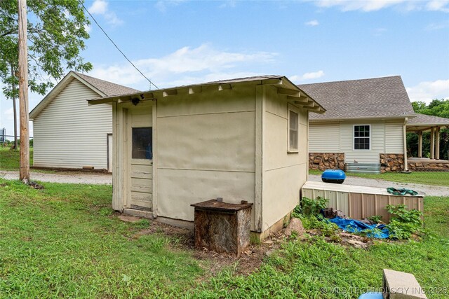 616 S Schlegel, Cushing, OK 74023 - view of side of home featuring a lawn and roof with shingles