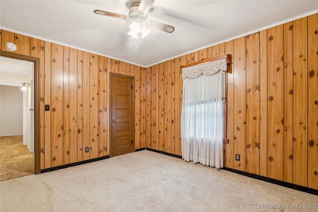 307 S Cherokee, Locust Grove, OK 74352 - carpeted empty room with crown molding, a ceiling fan, wooden walls, baseboards, and a smoke detector