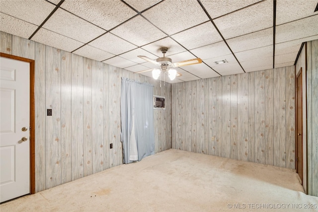 307 S Cherokee, Locust Grove, OK 74352 - spare room featuring carpet, a drop ceiling, wood walls, and ceiling fan