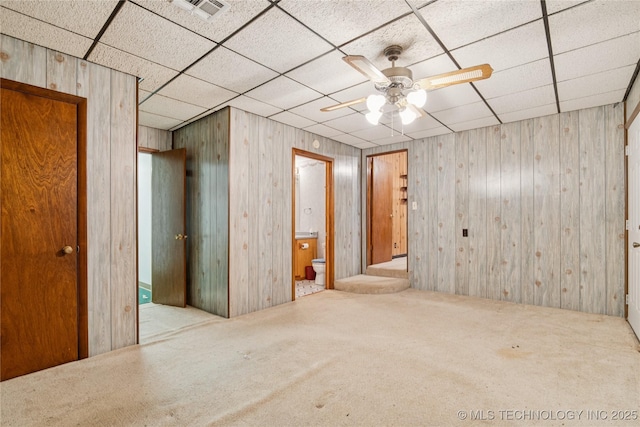 307 S Cherokee, Locust Grove, OK 74352 - carpeted spare room featuring ceiling fan, a paneled ceiling, and wooden walls