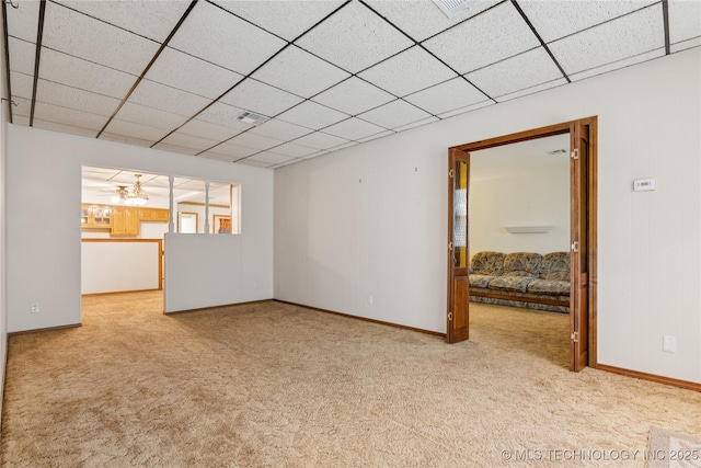 307 S Cherokee, Locust Grove, OK 74352 - unfurnished living room with carpet floors, a chandelier, baseboards, and a drop ceiling