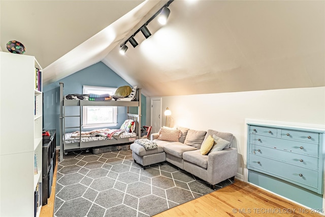109 E 14th St, Pawhuska, OK 74056 - living area featuring rail lighting, lofted ceiling, and dark wood-style floors