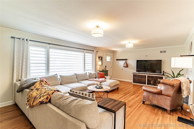 109 E 14th St, Pawhuska, OK 74056 - living area with crown molding, baseboards, and light wood finished floors