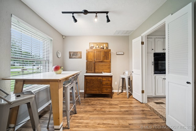 12350 E 138th St S, Broken Arrow, OK 74011 - home office featuring rail lighting, light wood-style flooring, and baseboards