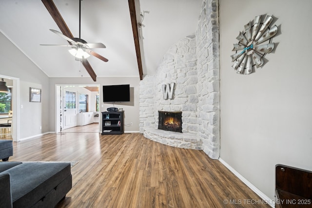 12350 E 138th St S, Broken Arrow, OK 74011 - living room with beamed ceiling, ceiling fan, wood finished floors, a stone fireplace, and baseboards