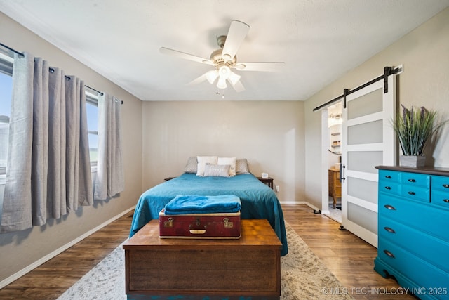 12350 E 138th St S, Broken Arrow, OK 74011 - bedroom featuring a barn door, wood finished floors, baseboards, and ceiling fan