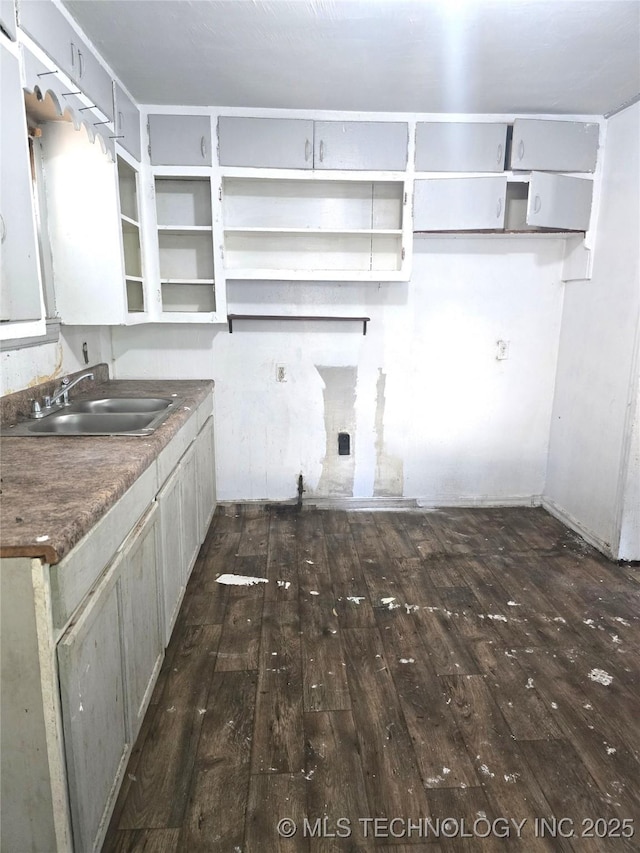 701 4th Ave SE, Ardmore, OK 73401 - kitchen featuring dark wood-type flooring, a sink, and open shelves