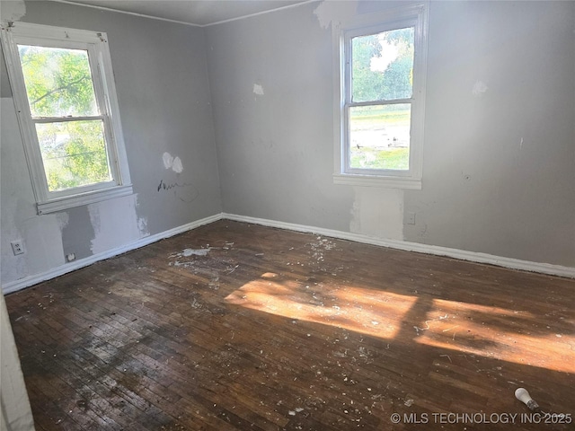 701 4th Ave SE, Ardmore, OK 73401 - spare room with hardwood / wood-style flooring and baseboards