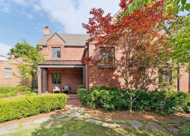 302 E 29th St, Tulsa, OK 74114 - view of front of home with brick siding, a standing seam roof, a chimney, roof with shingles, and a porch